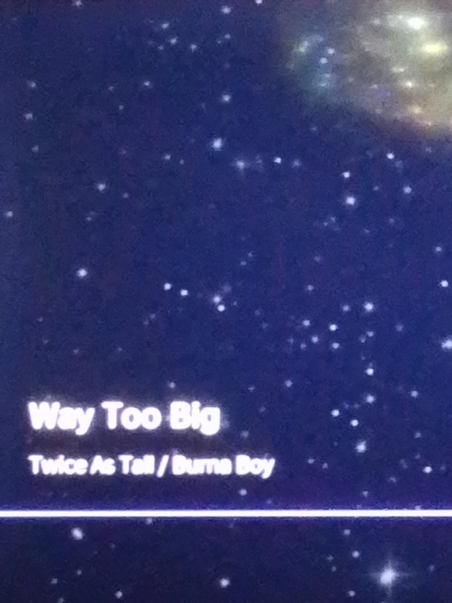 The image displays text overlaid on a dark, starry background, possibly representing a screen or a visual display. The text reads "Way Too Big" in a larger font, followed by "Twice As Tall / Burna Boy" in a smaller font. There is a horizontal line below the text. The background appears to be a nebula or a galaxy with numerous small, bright white dots representing stars. The image does not contain any recognizable landmarks or features that would indicate a specific location within Rumuomasi, Nigeria.