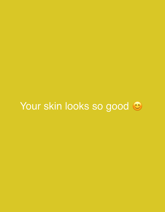 The image is a digitally rendered image with a solid yellow background. Text in white reads "Your skin looks so good" with a smiling face emoji to the right of the text. The image is not a photograph and therefore does not depict any specific location in Jalingo, Nigeria, or any other real-world setting.