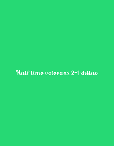 The image displays a solid, uniform green background. Centered horizontally on this background, the white text "Half time veterans 2-1 shitao" is present in a cursive font. No other visual elements, such as people, objects, actions, or environmental details, are depicted. The scene provides no discernible information regarding a specific location within Kakamega, Kenya, or any other geographical area.