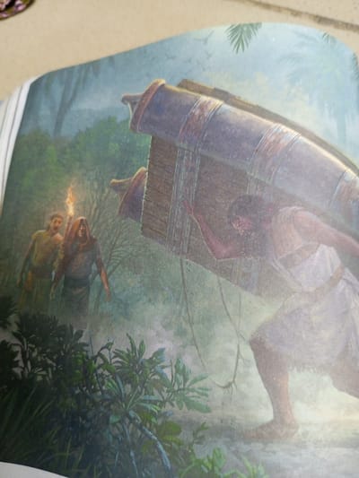 This painting depicts a scene set in a jungle environment, likely in Jauro Yinu, Nigeria. The primary subject is a muscular man, barefoot and wearing a light-colored garment, who is struggling to carry a large, cylindrical object. This object appears to be made of wood and metal, with rusted bands around its circumference. The man's posture suggests immense effort and strain.
Behind him, two other figures are visible in the background. The figure in front is cloaked and holds a torch, illuminating the path. The second figure, further back, is wearing a simpler tunic. They appear to be accompanying or guiding the man with the heavy load.
The setting is a lush jungle with dense foliage in the foreground, including various green leaves and branches. In the background, palm fronds are visible against a misty, atmospheric sky. The lighting suggests either dawn or dusk, with a soft, diffused light and a sense of mystery. The overall mood is one of arduous labor and perhaps a journey through a challenging environment. There is no visible text in the image.
