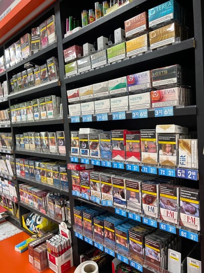 This image shows a shelf display filled with various tobacco products in what appears to be a retail environment. The products include cigarettes, as well as IQOS tobacco products like TEREA, LEVIA, and HEETS, with the prices marked in both Bulgarian lev (лв.) and euros (€). The packaging of the cigarettes includes graphic health warnings in Bulgarian. The display appears well-stocked and organized, with each brand and type of product arranged neatly. There are also some accessories or smaller items, possibly lighters, visible on the lower shelves. The location could be a convenience store, gas station, or a specialized tobacco shop, likely in Cherven Bryag, Bulgaria.