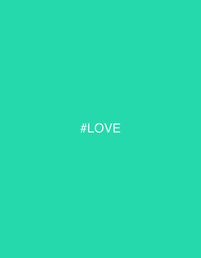 The image displays a uniform, solid teal-green background. Centered on this background is the white text, "#LOVE", rendered in capital letters with a leading hashtag symbol. No individuals, additional objects, actions, or interactions are present in the scene. The abstract composition provides no discernible environmental context or specific location within the city of Roubaix, France, or any other geographical area.