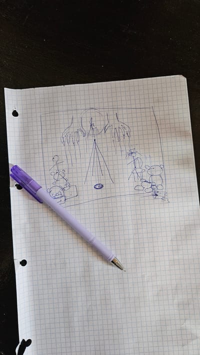 The image shows a close-up, high-angle shot of a piece of graph paper with a sketch and a light purple pen. The sketch, drawn in blue ink, appears to be a diagram or conceptual drawing. On the left side of the paper, there is a large circular object with radiating lines, resembling a lens or a light source, with what looks like hands reaching towards it. Above this, there are several circular shapes, possibly depicting a cluster of objects or a biological structure. To the right of the central diagram, there are some rectangular shapes and small figures that resemble people. A purple pen with a clear cap rests diagonally across the right side of the paper. The graph paper has punched holes along the bottom edge, indicating it is from a binder. The background is a dark, textured surface, likely a table. The lighting suggests it is daytime, possibly indoors. No visible text is present in the image.