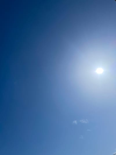 The image shows a clear blue sky with the sun prominently displayed. The sun is bright and appears to be high in the sky, suggesting it is midday. There are faint white clouds scattered across the sky, indicating fair weather. The overall scene is one of a sunny day, likely outdoors. No people, objects, or text are visible in the image. The location context of Santa Marta, Colombia, suggests a tropical or subtropical climate, consistent with the bright sunshine.