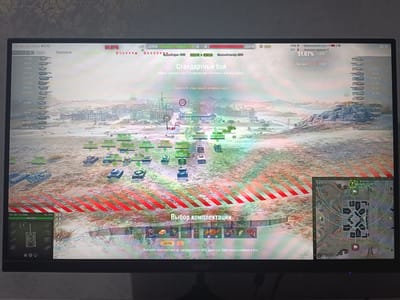 The image shows a screenshot of a computer game, likely World of Tanks, displaying a battle in progress. A player's perspective is shown with a list of tanks on the left side of the screen and a minimap in the upper right. The game environment depicts a city with buildings and terrain, with several tanks visible on the battlefield. The central part of the screen shows game information, including the match type, objectives, and statistics. There are no people visible in the image. The location of Kurchaloy, Russia is not depicted or mentioned in the screenshot.