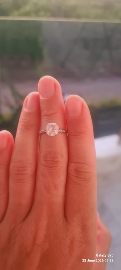 A close-up, over-the-shoulder shot shows a hand wearing a silver ring with a large, clear stone and small stones on the band. The ring is centered on the middle finger, and the hand is positioned in front of a blurred background of green foliage. The image includes a timestamp in the bottom right corner: "Galaxy S20 22 June 2026 05:32". The setting appears to be outdoors, possibly a garden or a natural area, with no specific landmarks to identify a location within Dalaman, Turkey.