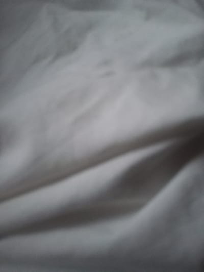 The image shows a blurred, abstract texture of draped fabric. The lighting creates subtle shadows and highlights, suggesting soft folds and a matte finish. There are no discernible people, objects, actions, or specific environmental details visible. The location of Gyulagarak, Armenia is not evident in the provided image.
