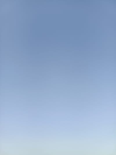 The image displays a clear, pale blue sky with a subtle gradient, transitioning to a lighter hue towards the horizon. There are no discernable objects, people, or structures visible in the frame. The scene appears to be an outdoor, wide-angle view of the sky. The location is identified as Nezavertaylovka, Moldova.