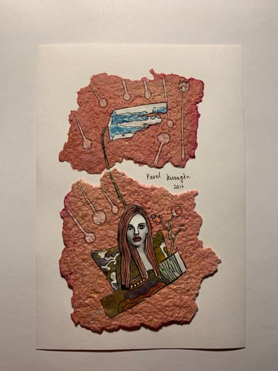 The image is a photograph of a collage artwork mounted on white paper. The collage consists of two torn pieces of textured pink paper, onto which various elements have been attached and drawn.
The upper piece of pink paper features a drawing of a blue and white object, possibly a stylized representation of technology or a fragmented landscape, with thin lines extending from it, each ending in a circular shape with a stem. These lines and circles appear to be hand-drawn.
The lower piece of pink paper contains a drawing of a woman with long, reddish-pink hair, striking features, and red lips. She is depicted with a detailed outfit. Next to her, on the right, are delicate drawings of flowers and leaves. Below her, elements of a patterned fabric or material are visible, suggesting she is part of a larger composition. Several of the same stem-and-circle motifs from the upper section are also present on this lower piece.
In the space between the two pink paper elements, handwriting reads "Pavel Kuragin 2016".
The artwork is lit from the top, casting a shadow to the bottom right. The white paper it is mounted on appears to be textured. The overall scene is a close-up, flat-lay photograph of this artwork. The location in the city of Sergeevo, Russia, is not discernible from the image itself.