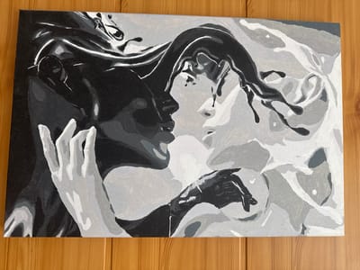 The image displays a painting of two faces in profile, nearly touching. The painting is rendered in grayscale, with stark contrasts between black and white, and various shades of gray in between. The figures appear to be merging or interacting intensely, with strands of what looks like hair or fabric flowing between them. One figure is primarily in black and dark gray, with lighter gray highlights on its hand and parts of its face. The other figure is predominantly in white and light gray, with dark gray elements around the eye and mouth area, and a hand rendered in dark gray. The style of the painting is abstract and stylized, with broad brushstrokes and defined planes of color.
The painting is situated on a wooden surface with a visible grain pattern, suggesting it is either hanging on a wall or placed on a table. The lighting appears to be natural and comes from the top left, casting subtle shadows on the wooden surface. The painting is rectangular and oriented horizontally.
There is no indication of the city of Vurnary, Russia, or any specific urban location within the provided image. The scene depicted is an artistic representation of faces and is not a photograph of a real-world location or event.