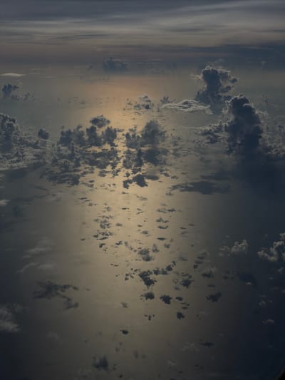 The image shows an aerial view of clouds over a body of water. The lighting suggests either sunrise or sunset. No people or objects related to Taoyuan City, Taiwan, are visible.