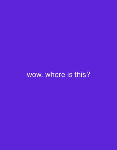 The image displays a solid purple background. Centered horizontally and vertically on this background is white, sans-serif text. The text reads: "wow. where is this?". No people, physical objects (other than the text itself), actions, or interactions are depicted. The background is a uniform color field, providing no environmental context or physical location details, and therefore, no specific location within the city of Erba, Italy, or any other geographical area, can be identified or described from the image content.