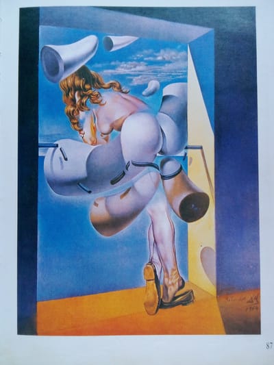 This is a surrealist painting depicting a disembodied female torso and legs emerging from various abstract, trumpet-like forms and structural elements. The figure has long, wavy blonde hair and is positioned in a contorted, dynamic pose. The scene appears to be set outdoors with a bright blue sky and scattered clouds.

The environment is abstract, with angular, geometric shapes suggesting an interior space opening to the sky. One corner of the structure is a deep blue, while another is a pale yellow. The ground is a vibrant orange. The figure is rendered with anatomical detail, but its integration with the surrounding objects is dreamlike and illogical. Some of the trumpet-like forms are large and white, appearing to emerge from or surround the figure, while others are smaller and white, floating in the sky.

The overall mood is one of disquiet and strangeness, characteristic of surrealism. There are no specific cues about the time of day or weather beyond the bright sky, suggesting a fantastical setting. The painting is signed in the bottom right corner with what appears to be "Dali" and "1954." There is also a number "87" printed in the bottom right corner of the overall image, likely a page or plate number. The location context of Zhmerynka, Ukraine, does not appear to be visually represented within the painting itself.