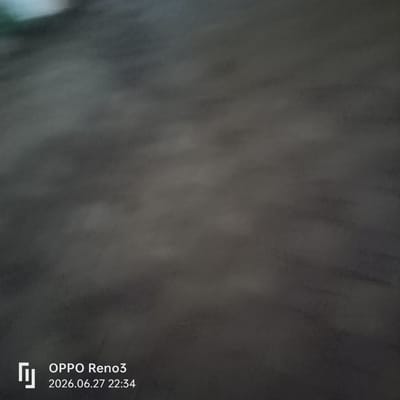 This is a dark, somewhat blurry image with a watermark in the bottom left corner. The watermark includes the text "OPPO Reno3" and the date "2026.06.27 22:34". The background appears to be a textured, dark surface, possibly concrete or stone, with some lighter, diffused areas that could suggest reflections or varying light conditions. There are no discernible subjects like people or distinct objects in the frame. The overall impression is of a dimly lit, nondescript environment, captured in the evening given the timestamp. No specific activity or event is depicted. The location context of Atyrau, Kazakhstan, does not offer any immediate visual cues within the image itself.