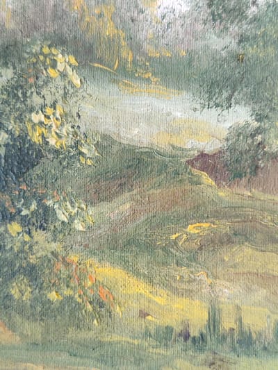 The image is a close-up, cropped, vertical shot of an oil painting. The painting depicts a landscape with rolling hills covered in green foliage. There are prominent trees on the left side of the frame, with some yellow and orange-hued leaves suggesting a late summer or early autumn setting. Sunlight appears to be dappling through the trees and illuminating parts of the landscape with streaks of yellow and white. The texture of the canvas and the impasto technique of the oil paint are clearly visible. The painting style is impressionistic, with a focus on light and color rather than precise detail. There are no discernible human figures or specific landmarks that would suggest a particular location within Rybnitsa, Moldova. The scene is peaceful and naturalistic.