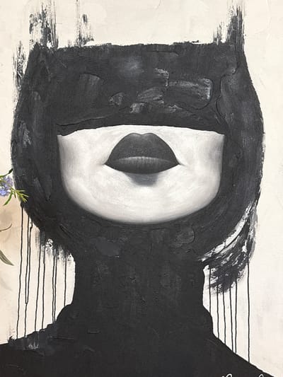 The image presents a close-up view of an abstract, mixed-media artwork characterized by a monochromatic palette of black, white, and shades of gray. The central subject is a prominent, textured white form, resembling an elongated almond or an eye, which contains a darker, almost black, oval shape at its core.
This white form is enveloped and partially framed by a thick, textured mass of black paint that extends across much of the canvas. The black paint exhibits significant impasto and visible brushwork, creating ridges, coarse textures, and deliberate scratch-like marks, particularly evident on the left and upper edges. These textural elements give the black areas a sculptural quality.
To the right of the central abstract "eye," the dense black paint gives way to a lighter background where several thin, parallel black horizontal lines are visible. These lines, distinct from the heavily textured paint, appear drawn or thinly painted on the light surface.
The surrounding background, not covered by the artwork's black elements, is a subtly textured, light cream or off-white surface, likely the underlying canvas or a wall. In the lower center of the frame, a small sprig of green leaves with a few delicate light purple or blue flowers is visible, suggesting the artwork is displayed alongside floral elements or is part of a broader arrangement. No text is visible in the image. The strong contrasts and abstract forms contribute to a sense of depth and contemplation.