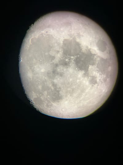 This media file is a close-up photograph of the Moon against a dark, black background, likely space. The Moon is partially illuminated, with its visible surface showing numerous craters and variations in texture, suggesting a significant phase of its illumination, possibly a full or near-full moon. The details of the lunar surface, such as the craters and maria (dark, basaltic plains), are clearly discernible. The image is shot from an Earth-based perspective, likely through a telescope, given the level of detail captured. There are no people, text, or specific location cues within the image itself that would indicate Târgu Neamț, Romania, or any particular time of day or weather conditions beyond the context of observing the night sky. The focus is solely on the celestial body.