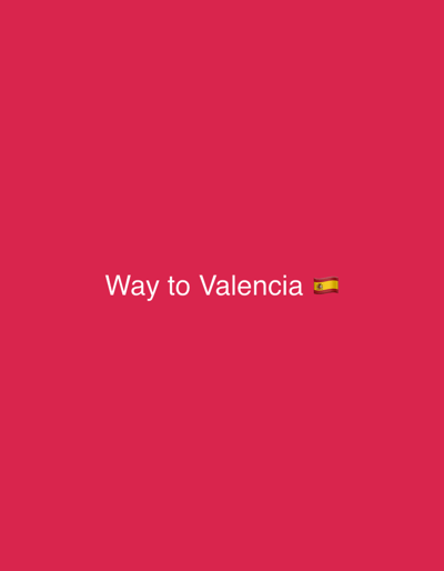 The image depicts a digital graphic on a solid magenta-red background. White text, "Way to Valencia", is centered horizontally in the lower-middle area of the frame. Immediately following this text is a Spanish flag emoji. The scene, entirely composed of these graphic elements, is located in Almenara, Spain. There are no individuals, physical objects, actions, interactions, or discernible environmental details present beyond the text and emoji on the colored background.