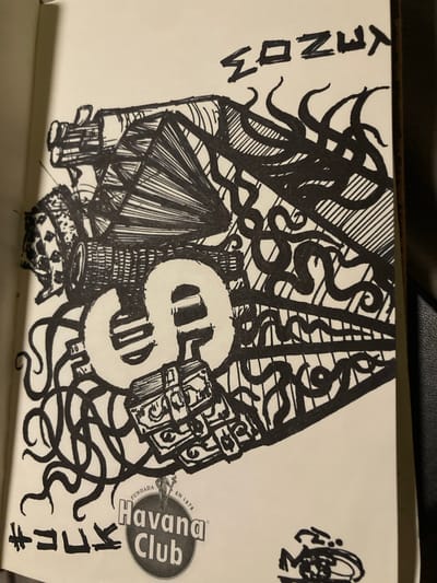 This is a black and white drawing on a light-colored background, possibly a page from a sketchbook. The drawing features a large, stylized dollar sign as its central element. To the left of the dollar sign, the word "MONEY" is written vertically in block letters. The dollar sign is surrounded by intricate, abstract patterns, including swirling lines that resemble tentacles or vines, as well as geometric shapes and shading.
To the lower left of the dollar sign, there is a depiction of a crown and what appears to be a small building or structure with vertical lines. To the right of the dollar sign, there is a circular logo with the text "Havana Club" and "EN 1878 FUNDADA CIUDAD." Above this logo, there are some small, abstract black ink scribbles. To the far right, there are some Japanese characters written vertically.
The style of the drawing is detailed and has a somewhat surreal or chaotic feel due to the combination of recognizable symbols like the dollar sign and crown with abstract and organic forms. There are no clear indicators of time of day, weather, or specific emotions, but the imagery of money, a crown, and the Havana Club logo could suggest themes of wealth, power, or indulgence. The presence of Japanese characters and the Havana Club logo, a Cuban rum brand, hints at a possible interest in global culture or branding. The location context of Sabadell, Spain, does not appear to be directly depicted in the drawing itself.