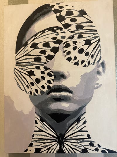 The image is a painting of a person's face and upper torso, rendered in grayscale with butterfly wing patterns. The butterfly wings obscure the eyes and are also depicted on the neck and chest, forming a bow-tie shape. The painting is on canvas and is not located in Orsk, Russia.