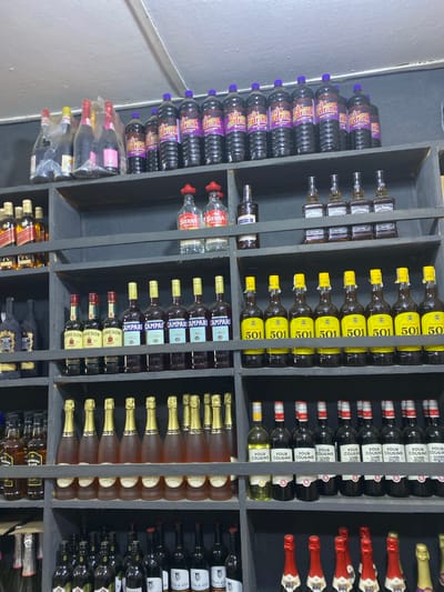 The image shows a shelf stocked with various alcoholic beverages in what appears to be a retail setting. Brands like "Four Cousins", "501", "Campari", "Jameson", and "Sierra Tequila" are visible. The bottles are neatly arranged, suggesting an organized display in a store or bar. While the image does not include people, it implies a commercial environment where these items are sold or stored. There is no specific detail in the image that mentions the exact location in the city of Epe, Nigeria.