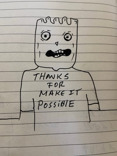 A hand-drawn illustration on lined paper depicts a figure wearing a t-shirt that reads "THANKS FOR MAKE IT POSSIBLE." The figure has a square-shaped head with two wide eyes, a small triangular nose, and a jagged, open mouth. The t-shirt has short sleeves and the text is written in block letters across its chest. The drawing is in black ink on a piece of paper with horizontal lines, reminiscent of a notebook page. There is no discernible city or location in Venezuela referenced or depicted in the image.