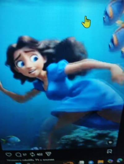 A cartoon image displays a young woman with dark hair and blue eyes wearing a blue dress, submerged in blue water. She appears to be in distress, with her mouth open and eyes wide. Her left arm is extended, as if reaching out. Several blue and yellow fish are visible in the background. A yellow hand cursor is superimposed on the image in the upper right quadrant. The bottom of the image shows what appears to be a web browser interface with icons and text. The scene is set in an underwater environment, possibly a fictional one. There is no discernible information in the image to indicate its location in Kingisepp, Russia.