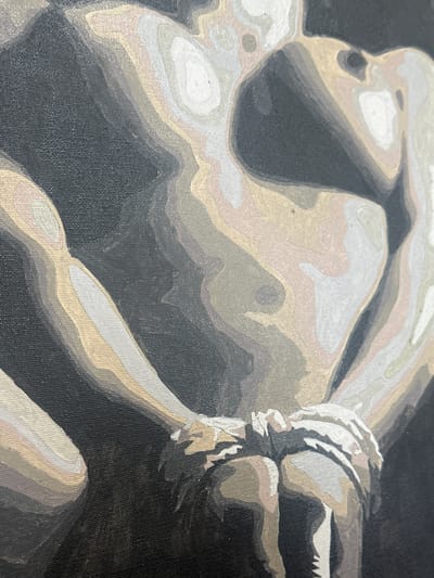 A close-up of a grayscale painting on canvas depicting a human figure. The figure appears to be bound, possibly in a reclining position. The painting uses distinct layers of gray, white, and light brown to define the forms, with a black background. The artwork is close-up, showing only a portion of the figure, with rope at the right side of the scene.
The information regarding the location in the city of Vysoky, Russia, is not depicted in the image provided.