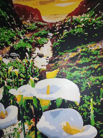 This is a painting of a natural landscape. In the foreground, there are several white calla lilies with yellow stamen. The background depicts a rocky, overgrown hillside with a suggestion of a creek or stream. The sky above is a gradient of yellow and orange, suggesting sunset or sunrise. The style of the painting is somewhat abstract and blocky, with bold colors and defined shapes. There are no people or buildings visible in the image. The painting does not provide any information about the city of Yampil, Ukraine.