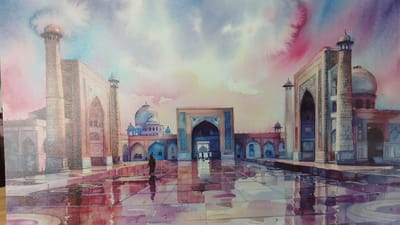 This is a watercolor painting of a mosque complex in Nurafshan (Toytepa), Uzbekistan. The scene depicts the courtyard of the mosque with its distinctive architecture, including minarets, domes, and arched doorways. The ground is wet and reflective, suggesting recent rain or a fountain, creating mirror-like images of the buildings and the sky. The sky is filled with vibrant, swirling colors, ranging from pinks and oranges to blues and purples, indicating either a sunrise or sunset. A lone figure, dressed in dark clothing, walks across the courtyard, their reflection visible on the wet surface. The overall impression is one of serene grandeur and atmospheric beauty.
