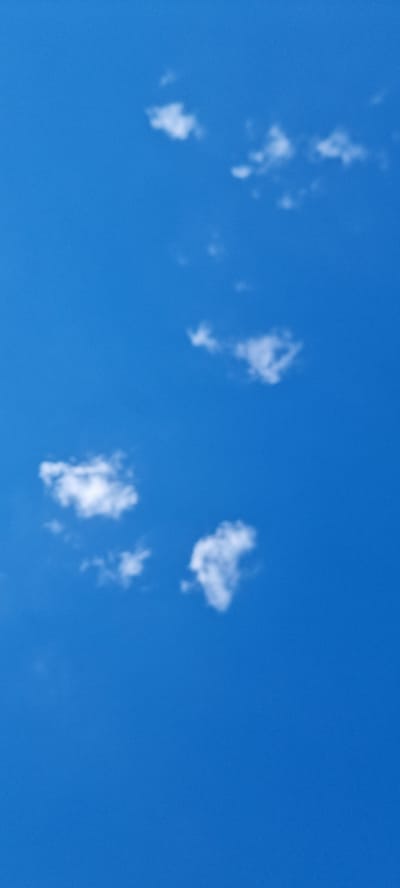 The image shows a clear blue sky with several small, wispy white clouds scattered across it. There are no buildings, people, or any other discernible objects visible. The scene depicts a natural outdoor environment. The location in Bobrovo, Russia is not specified or evident from the image.