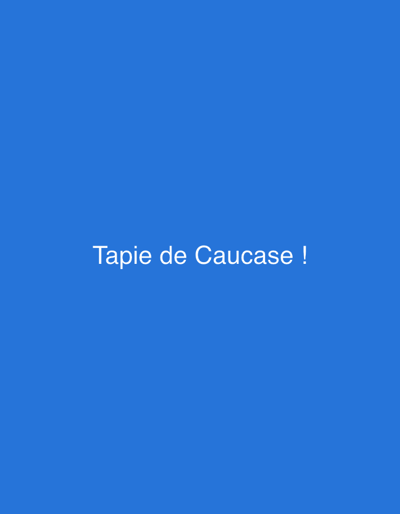 The image is a plain blue background with white text in the center. The text reads "Tapie de Caucase !". There are no people, objects, or environmental details visible. The location in the city of Saint-Quentin, France is not discernible from the image.