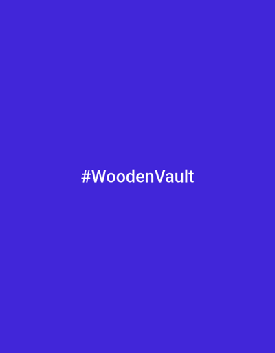 The image is a static graphic with a solid, vibrant purple background. Centered in the frame, written in white sans-serif text, is the hashtag "#WoodenVault". The text is clean and easily readable against the dark background. There are no people, objects, or environmental details depicted; the image is solely focused on the text against a monochromatic backdrop. The overall presentation is minimalist and graphic design-oriented, likely intended for social media or branding purposes. There are no discernible cues about the time of day, weather, or specific location beyond the textual content. The emotion conveyed is neutral due to the absence of any figurative elements.