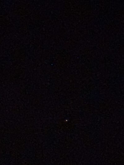 The image appears to be a night sky view. Two small, faint points of light, likely stars, are visible against a dark background. One star is bluish, and the other is yellowish. It is impossible to determine the location of Gorleston-on-Sea or any details regarding people, objects, actions, or interactions without additional information or visual cues within the image.