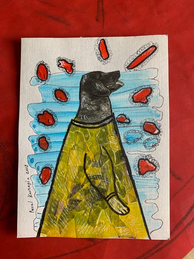 The image is a painting on a white canvas, placed on a red textured surface. The painting depicts a stylized animal, likely a dog, wearing a yellow patterned garment. The background of the painting consists of blue horizontal stripes interspersed with red, irregularly shaped elements, each outlined in black and a decorative, wavy line. The dog has a dark head with its mouth open. Below the dog's head is a suggestion of a collar or neckband. The yellow garment appears to have a textured surface and is adorned with a subtle pattern. The painting is signed on the bottom left in cursive text, "Pavel Kuragin 2018".
The red surface upon which the canvas rests has visible lines or textures, suggesting it might be a table or a piece of fabric with a prominent pattern. The overall aesthetic is abstract and somewhat whimsical. There is no information within the image itself that would suggest a specific location in the city of Sergeevo, Russia.