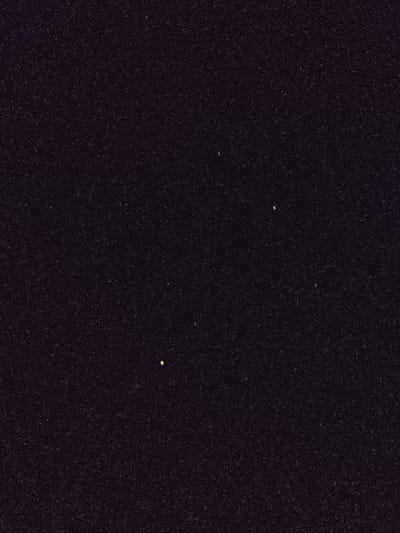 The image depicts a dark night sky with a few stars visible. The coordinates provided place the location in the vicinity of Mayo, Trinidad and Tobago. The scene is characterized by the absence of any other visual elements, except for the stars.  The image suggests a clear night sky with minimal light pollution.