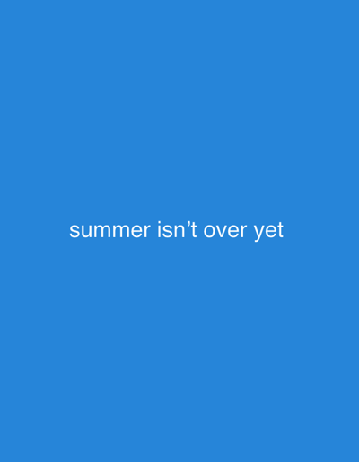 A white text overlay on a solid blue background reads "summer isn't over yet." The image is not located in Lusail, Qatar, but is a digital graphic. There are no people, subjects, objects, actions, interactions, or environmental details to describe.