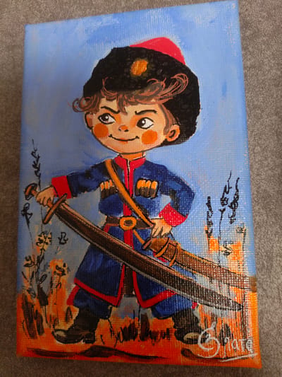 This is a painting of a young boy dressed in traditional Cossack attire, standing in a field. He wears a blue uniform with red trim, a black papakha hat with a red top, and is holding two sabers. The boy has a mischievous smile and rosy cheeks. The background depicts a blue sky with sparse, abstract brushstrokes suggesting foliage and possibly a building in the distance. The overall style is cartoonish and illustrative. The painting appears to be on canvas and signed by the artist in the lower right corner with what looks like "3ATe" and "2019". The setting, given the location context, is likely rural Russia. The time of day and weather are not specified, but the bright colors suggest a pleasant atmosphere. The emotions conveyed are those of playful confidence and youthful spirit.