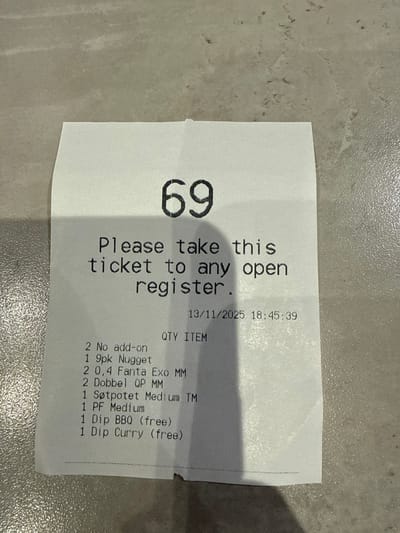 A receipt, numbered "69," instructs the holder to present it at any open register. The printed order details, dated November 13, 2025, at 18:45:39, includes "2 No add-on," "1 9pk Nugget," "2 0,4 Fanta Exo MM," "2 Dobbel QP MM," "1 Søtpotet Medium TM," "1 PF Medium," "1 Dip BBQ (free)," and "1 Dip Curry (free)." The quantity of each item is also noted.
