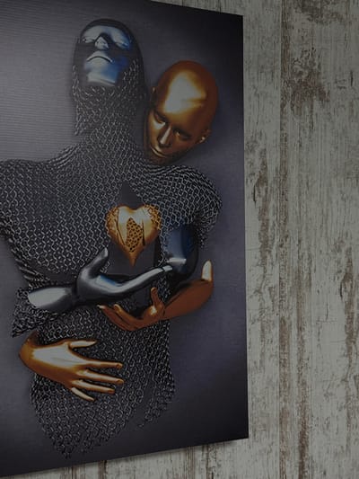 This media file showcases a close-up, high-angle view of a piece of art displayed on a textured, light-colored wooden surface. The artwork itself is a surreal composition featuring two stylized figures, or perhaps parts of figures, rendered with a metallic sheen. One figure appears to be a golden head with closed eyes, lying on its side. Partially covering it is a dark, chainmail-like texture. Beneath and intertwined with this is another form, a head with a blue metallic finish, also appearing to be resting.

The central focus of the artwork is a metallic silver hand gently reaching out towards a golden hand with outstretched fingers, which appears to be resting on the chainmail texture. Between these hands is a golden, heart-shaped object with a grid-like texture in its center. The overall color palette is dominated by metallics – gold, silver, and blue – against a dark, textured background. The artistic style suggests a blend of sculpture and digital art, creating an abstract and evocative image. The scene implies a moment of connection, tenderness, or perhaps a surreal interaction between these metallic forms. No text is visible in the image. The wooden surface suggests the artwork is likely displayed indoors, perhaps in a home or gallery setting. The mention of Yegorlykskaya, Russia, provides a geographical context for the image's origin or context, though it does not directly inform the visual content of the artwork itself.