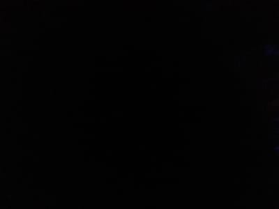 The image is almost entirely black, indicating near-total darkness or severe underexposure. Extremely faint, dark blue and reddish hues are barely discernible along the far right edge of the frame. No identifiable people, subjects, objects, actions, interactions, or environmental features are visible. The reported location is Long Beach, United States.