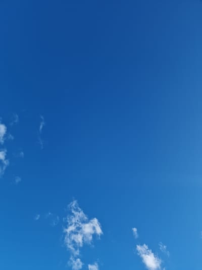 This media file shows a bright blue sky with scattered white clouds. The clouds are wispy and appear to be in the upper atmosphere. The overall impression is of a clear, sunny day. The time of day appears to be during daylight hours, possibly mid-morning or early afternoon, given the intensity of the blue and the brightness of the clouds. The location context provided is Kashgar City, China. There are no people or objects visible in the frame, and no text is present. The scene is a natural outdoor environment, focusing solely on the sky.