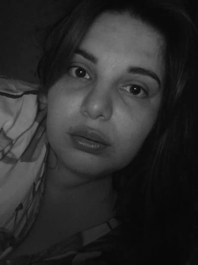 A close-up, black and white photograph shows a woman's face lying at an angle. The woman has medium-length hair. The background consists of what appears to be a patterned bed sheet. The location is not discernible as Амзя, Russia, based on the visual details.