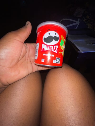 A person is holding a can of Pringles Original potato chips. The person's hand is visible in the lower left corner of the image. The can of Pringles is red with the Pringles logo and "ORIGINAL" printed on it. The person's thighs are visible in the upper right corner of the image. The background is dark and mostly out of focus, but there is a piece of furniture visible in the upper left corner.
I can not locate where the city of Kurunduma, Nigeria. is.