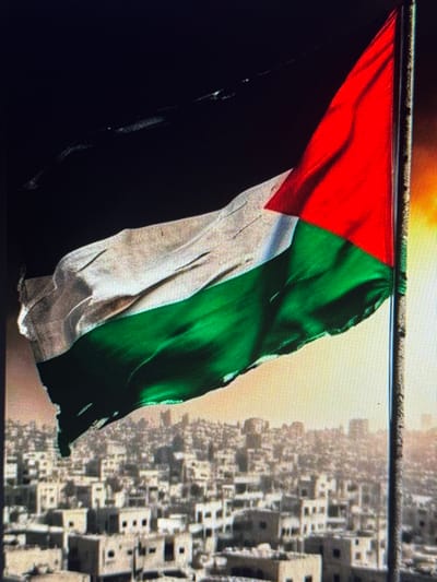 The image shows a Palestinian flag waving in the foreground, set against a backdrop of a dense urban landscape. The flag is composed of three horizontal stripes: black at the top, white in the middle, and green at the bottom, with a red triangle extending from the hoist side. The cityscape in the background consists of numerous buildings with flat roofs, appearing densely packed together. The lighting suggests it may be dusk or dawn, with a warm glow on the horizon. The image does not depict the city of Shcherbanka, Ukraine.