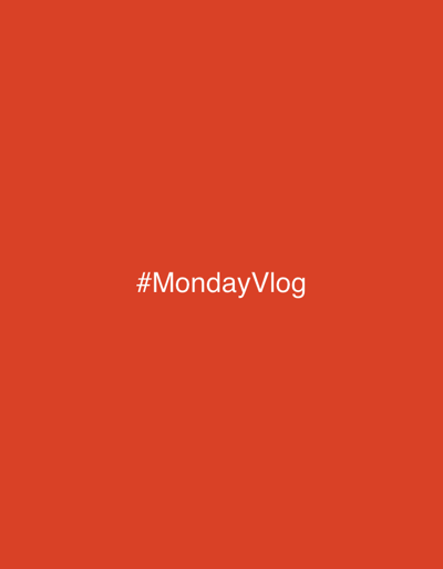 The image is a digitally created graphic with white text on an orange background. The text reads "#MondayVlog" and is centered horizontally and vertically on the screen. There are no people, objects, or environmental details visible. The graphic does not depict any location in Debelt, Bulgaria.