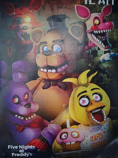 The image is a poster for "Five Nights at Freddy's," a video game. It features stylized, anthropomorphic animatronic animals, specifically Freddy Fazbear, Bonnie the Bunny, Chica the Chicken, Foxy the Pirate Fox, and Mangle. They are depicted with large, menacing smiles and sharp teeth. Freddy is in the center, wearing a top hat. Bonnie is to his left, holding a guitar. Chica is to Freddy's right, with a cupcake that has eyes. Foxy is in the upper left, wearing an eyepatch, and Mangle is in the upper right, a white and pink animatronic. The background is dark and somewhat blurred, suggesting an indoor, possibly derelict, location. The poster has a textured, slightly grainy appearance, consistent with a printed poster. The text "Five Nights at Freddy's" is visible at the bottom. There is no indication of the poster's location within Sinzheim, Germany; the image itself only depicts the poster's content.