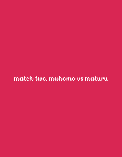 The image is a digital graphic with a solid reddish-pink background. Centered on the lower half of this background is white text in a handwritten script font that reads: "match two. muhomo vs maturu". The image does not depict any physical location within Lwandeti ward, Kenya, nor does it show any people, subjects, objects other than the text, actions, or interactions. The environment is entirely graphical.
