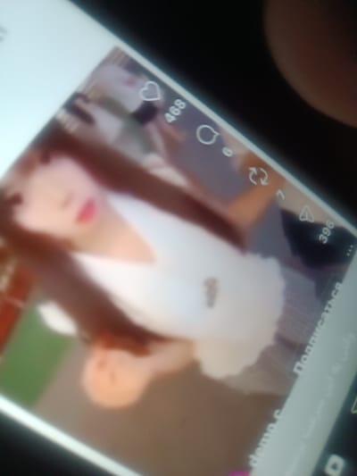 A blurry image of a phone screen displays what appears to be a social media video. The video features a person with long hair wearing a white top. Overlayed on the video are social media engagement icons. A heart icon with the number "468" indicates the number of likes, a comment icon, and a share icon with the number "7". A number "396" appears at the bottom right. The text "Подписаться" (Subscribe) is visible, along with other text at the bottom of the screen.