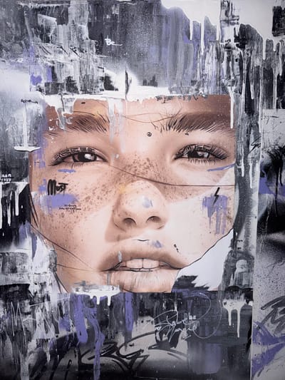 The image is a close-up, vertical portrait of a young woman's face rendered in a mixed-media style, likely a painting or a large-scale print with graffiti elements. The woman's eyes are wide open and looking directly at the viewer. She has freckles across her nose and cheeks. Her lips are slightly parted, revealing teeth.
The artwork is characterized by a strong contrast between the realistic depiction of the woman's face and the abstract, graphic elements surrounding it. There are drips of white paint running down from the top of the image, and swathes of purple and black paint create a textured, layered background. Graffiti tags and scribbled writing are visible in various parts of the image, particularly in the lower section. Some of these inscriptions are in English, such as "MOST" written in bold letters on her cheek. There is also a small peace symbol near her eye and a lightning bolt symbol on her cheek.
The location in the city of Solontsy, Russia is not identifiable from the image itself. The artwork is presented as a standalone piece, with no environmental context provided.